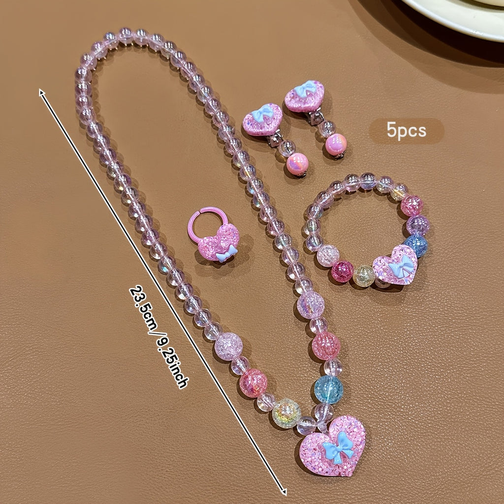 Conjunto de Joyería Infantil de 5 Piezas: Collar, Pulsera, Anillo y Aretes con Dije de Corazón Brillante y Lazo (Tonos Rosas)