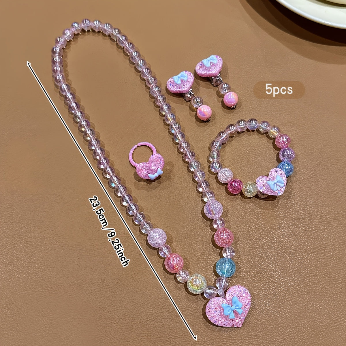 Conjunto de Joyería Infantil de 5 Piezas: Collar, Pulsera, Anillo y Aretes con Dije de Corazón Brillante y Lazo (Tonos Rosas)