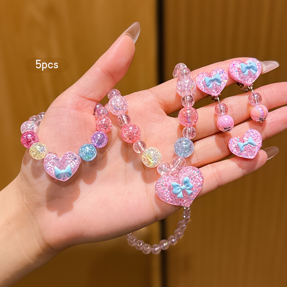 Conjunto de Joyería Infantil de 5 Piezas: Collar, Pulsera, Anillo y Aretes con Dije de Corazón Brillante y Lazo (Tonos Rosas)