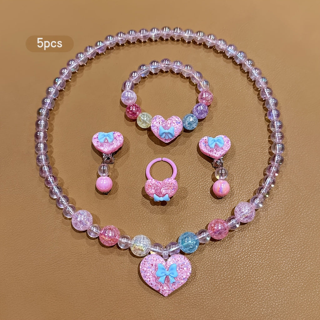 Conjunto de Joyería Infantil de 5 Piezas: Collar, Pulsera, Anillo y Aretes con Dije de Corazón Brillante y Lazo (Tonos Rosas)